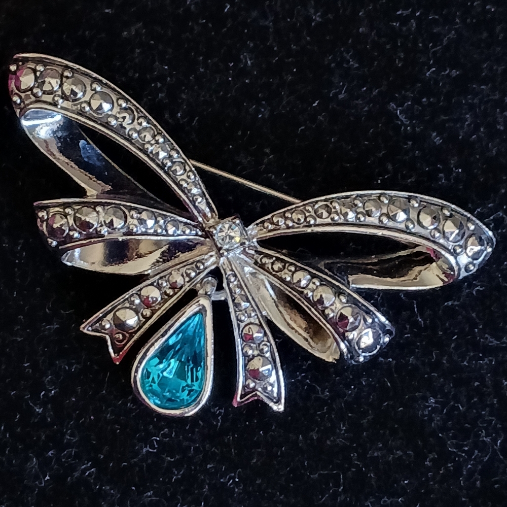 Vintage Avon silvertone bow brooch with turquoise colored pear shaped stone